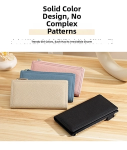 Close-up of pebble grain leather wallets in four colors on a wooden table with zipper detail