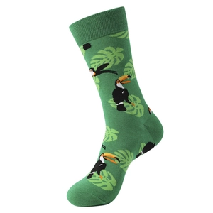 Detail of green mid-calf sock featuring knitted toucan bird and tropical leaf patterns
