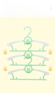 Vertical stacking detail of green bear-shaped kids hangers with anti-slip pads for space saving