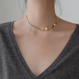 Gold-plated stainless steel necklace with smiley face charms and asymmetrical chain