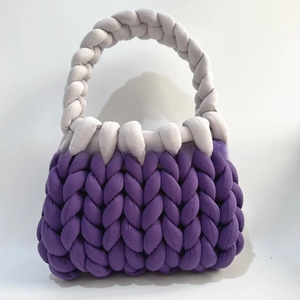 Close-up of handmade chunky knit handbag with deep purple and light grey thick yarn texture