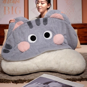 Close-up of huge soft plush cat pillow held by model showing extra large size and texture