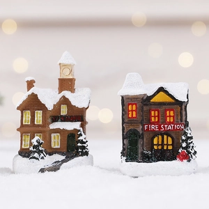 Miniature snowy Train and Fire Station ornaments with festive LED lights