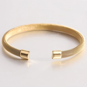 Minimalist gold 7mm mesh C-shape cuff bracelet with polished square ends on white surface
