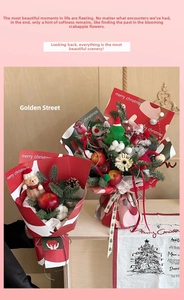 Detailed view of Christmas bouquet with red patterned paper, pine cones and small bear charm