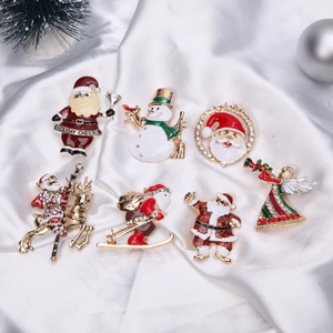 Detailed set of seven Christmas alloy brooches with enamel Santa Claus and snowman motifs