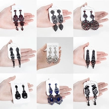 Close-up of nine styles of elegant alloy drop earrings with sparkling rhinestones and crystals