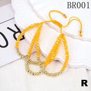Detail view of adjustable woven bracelet with yellow crystal beads and gold metal accents