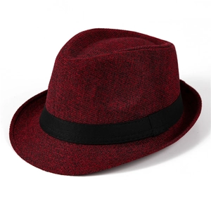 Detail of burgundy woven fedora hat featuring a black decorative band and fine texture