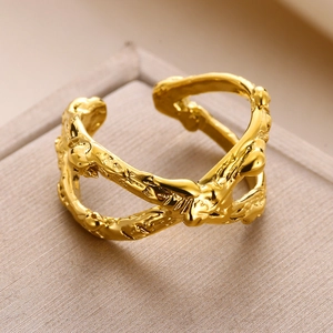 Macro detail of golden open ring with irregular organic texture and molten lava design