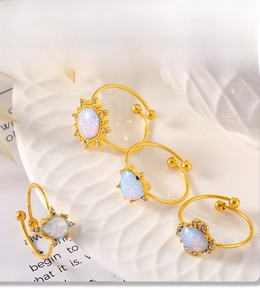 Detail showing PVD electroplated gold rings with opal stones and zircon accents