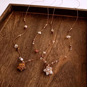 Bohemian star pendant necklace with natural stone beads and woven brown cord