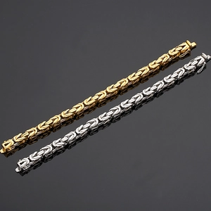 Detail of gold and silver Byzantine weave titanium steel chains with secure clasp