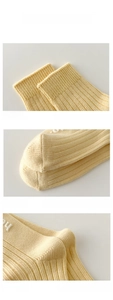 Detail of high-quality yellow cotton knit socks with elastic cuff and reinforced toe