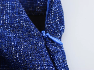 Macro shot of invisible zipper detail on premium blue tweed textured fabric set