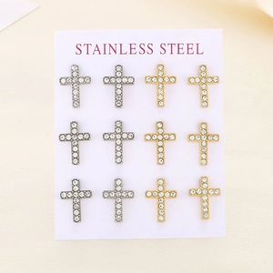 Detail of cross stud earrings set with sparkling crystals in gold and silver finish