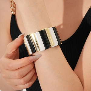 Detail of wide stretch bracelet with black, white and gold geometric color block