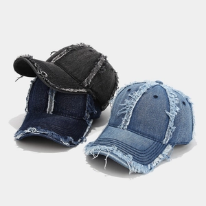Distressed denim baseball caps in black, navy, and light blue with frayed edge detail