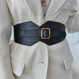 Women's vintage black crocodile embossed wide waist belt with golden buckle on a blazer