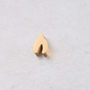 Macro shot of mirror-polished gold wishbone bead accessory for jewelry making
