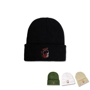 Detailed view of skull embroidery and multi-color options for this knit beanie