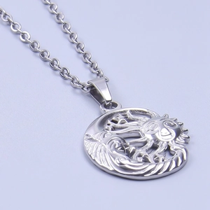 Macro shot of silver sun and moon cutout pendant in polished stainless steel