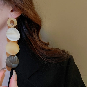 Statement acrylic drop earrings with marble texture hanging from a vertical chain