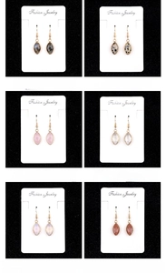 Detailed macro grid showcasing various marquise-cut gemstone drop earrings in gold finish