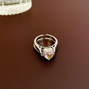 Detail of heart-shaped gradient zircon ring with sparkling pave stones and layered band
