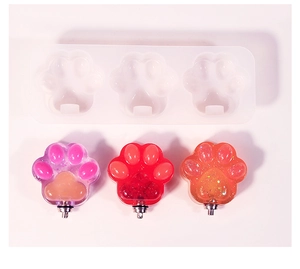 Cat paw silicone mold with resin glitter pendants in pink, red, and orange colors