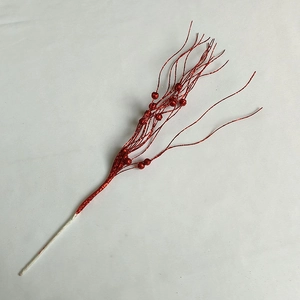 Close-up of red glitter Christmas floral stem with beads for festive home decoration