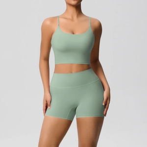 Detail of high-waist yoga shorts and strappy sports bra in sage green brushed fabric