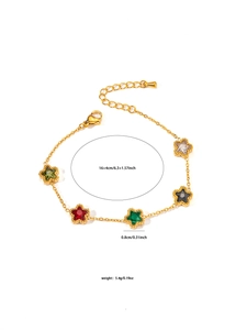 Close-up of golden star charm bracelet with colorful crystal inlays and adjustable clasp