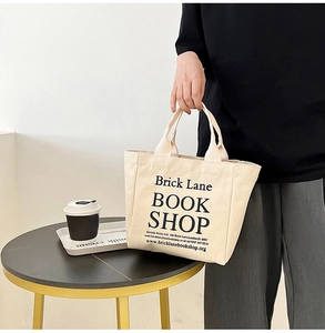 Detail of Brick Lane Bookshop beige canvas tote bag with black printed typography text