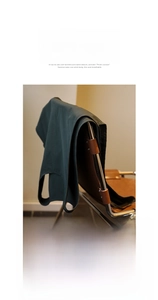 Detail of dark green anti-fouling apron on chair showing matte wrinkle-resistant fabric