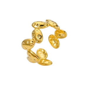 Detailed view of golden stainless steel open ring with textured oval plates and matte finish