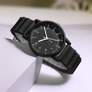 Detail of minimalist black sports watch featuring unique wavy textured silicone strap