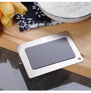 Detail view of a 304 stainless steel magnetic baking conversion plate on a rustic wooden board