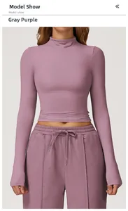 Front view of model wearing a grey-purple slim fit long sleeve yoga top with high collar