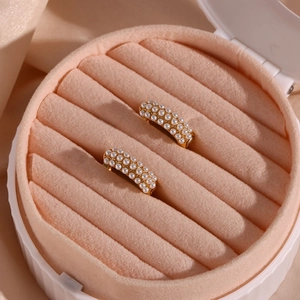 Detail of 18K gold-plated hoop earrings with micro-set pearls in a velvet gift box