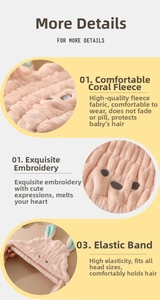 Detail view of pink coral fleece hair towel featuring bunny ears and elastic band