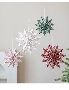 Close-up of laser-cut paper star ornaments with patterns for festive hanging decor