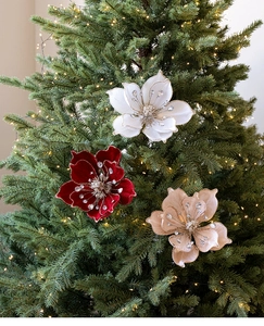 Close-up of velvet magnolia Christmas tree flowers with glitter edges and crystal beads