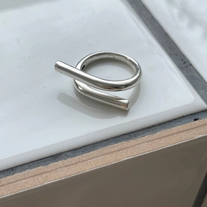 Macro shot of 925 sterling silver geometric ring featuring a sleek asymmetric open design