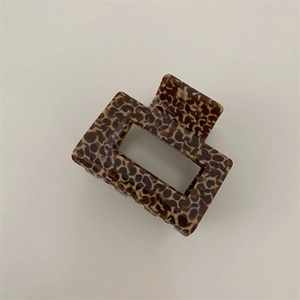 Close-up of leopard pattern square hair claw clip with sturdy metal spring detail