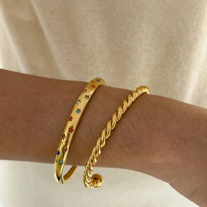 Golden bracelet set with twisted rope design and colorful star zircon inlays on model