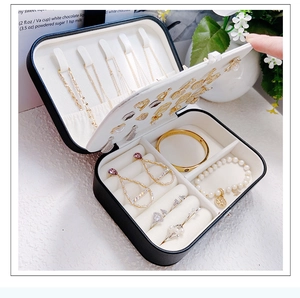 Close-up of black jewelry box with interior compartments for necklaces and rings