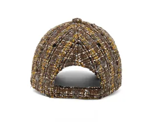 Detail view of the back of a winter tweed baseball cap with adjustable strap and texture