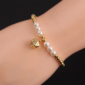 Elastic couple bracelet with gold beads, white pearls and a golden D20 dice pendant