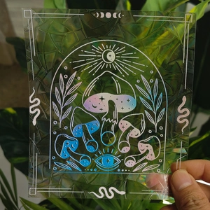 Holographic suncatcher window sticker featuring mushroom and celestial eye patterns